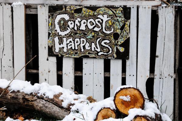 compost happens sign on wooden fence