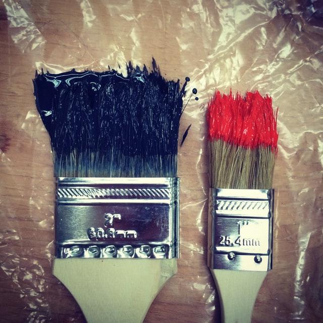 paintbrushes with dark blue and red paint